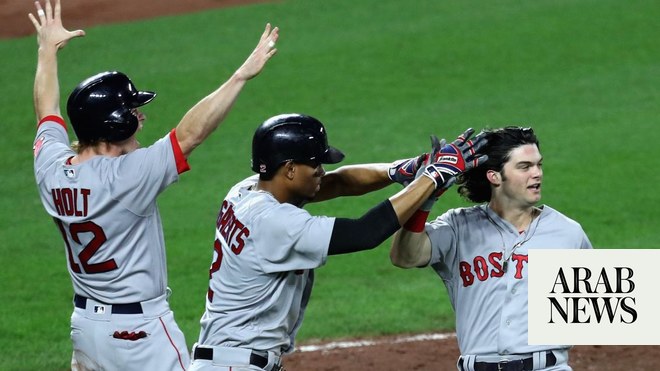 Xander Bogaerts and Brock Holt of the Boston Red Sox celebrate after