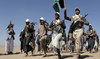 Houthi fighters march during a rally of support for the Palestinians in the Gaza Strip and against the US strikes on Yemen.