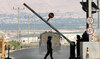 A man walks at a barrier, at the Allenby Bridge Crossing between the West Bank and Jordan.