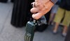 A man holds a walkie talkie device after he removed the battery.