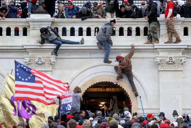 Supporters of US President Donald Trump fight with law enforcers at a door they broke open as they storm the US Capitol Building in Washington on Jan. 6, 2021. (REUTERS/File Photo )