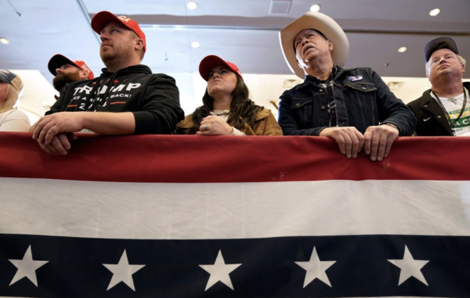 Audience members listen to former President Donald Trump speak during a commit to caucus rally on Dec. 13 in Iowa. (AP)