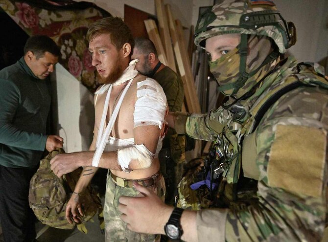 Medics help a local resident in a field hospital in the Kursk region on August 11, 2024. (AFP)